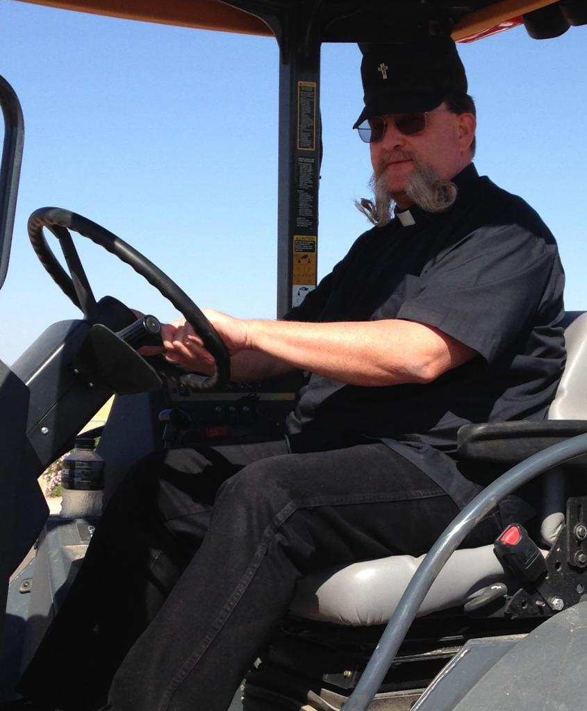 Father Branson on the back hoe.  He 