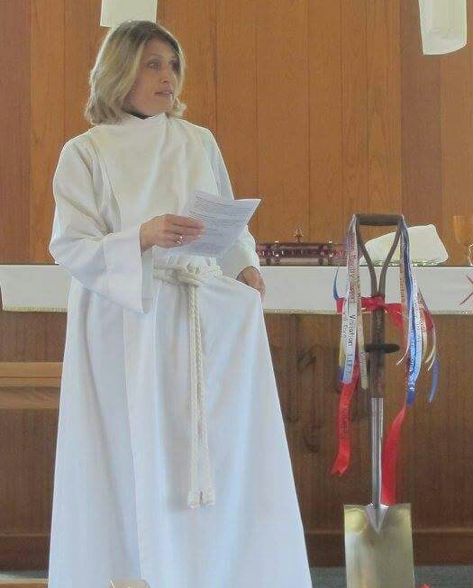 Pastor Alison on the day of groundbreaking for our new building, wirh the ceremonial shovel. The shovel has 63 ribbons, each with the name of a ministry in which the church is serving. 
